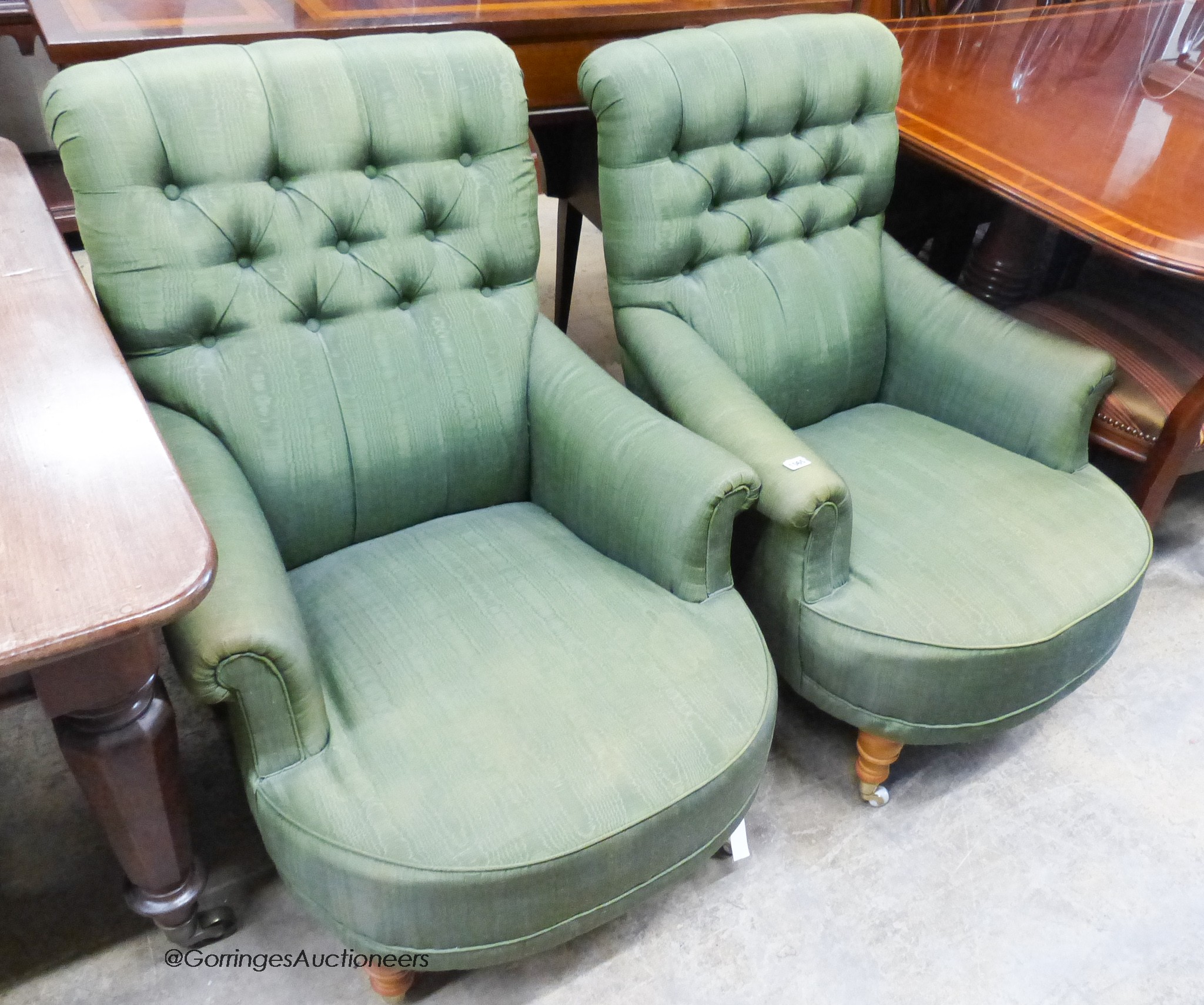 A pair of Victorian style armchairs upholstered in green moire silk.